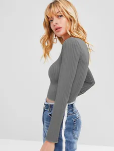 Detail of grey ribbed long sleeve crop top showing slim fit and textured fabric