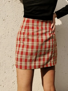 Détail d'une mini-jupe à carreaux rouges avec taille haute et motif tartan classique