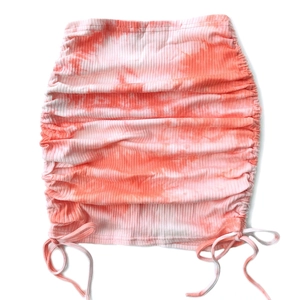 Detail of pink tie-dye mini skirt with ribbed texture and adjustable side drawstrings