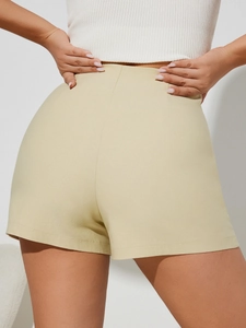 Fashionable beige high-waisted asymmetric skort shown from a detailed back view perspective