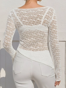 Back view of a white hollow knit long sleeve top with intricate crochet lace patterns