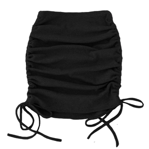 Detail of ruched black knit skirt with side drawstring and ribbed texture finish