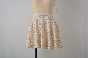 Detail of high waist floral chiffon skirt with purple and red flowers on beige