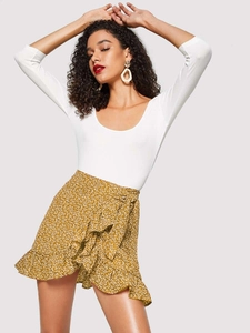 Detail of high waisted ginger floral mini skirt with ruffle hem and waist tie closure
