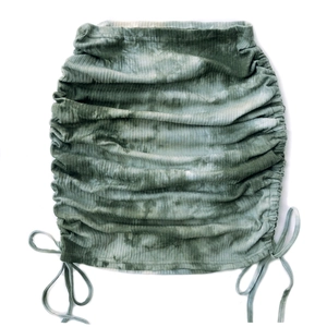 Detail of grey-green tie-dye knit skirt showing drawstring ruched texture and ribbed fabric