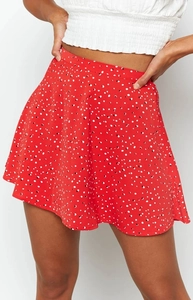 Detail of red high waist A-line mini skirt with vintage black and white polka dot pattern