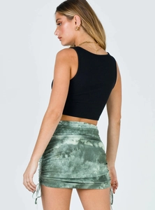 Detail of green tie-dye ruched mini skirt with side drawstring and ribbed crop top
