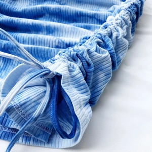 Detailed shot of blue and white tie-dye ribbed fabric with adjustable side drawstring