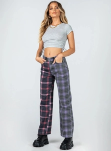 Detailed shot of casual grey crop top with side drawstring and asymmetrical plaid trousers