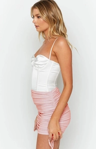 Detail of pink ribbed mini skirt with side drawstring and ruched texture design