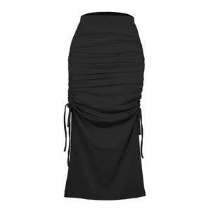 Detail of black ribbed knit skirt featuring elegant ruching and adjustable side drawstrings