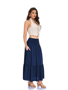 Close-up of wide elastic smocked waistband and layered hem on long maxi skirt