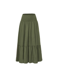Detailed view of the dark green tiered maxi skirt featuring a smocked elastic high waist
