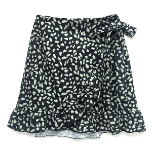 Detail of high waist leopard print skirt with side bow tie and ruffle hem design