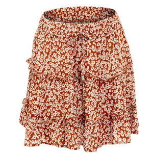Detail of high waisted floral skirt with drawstring ties and golden bead ends