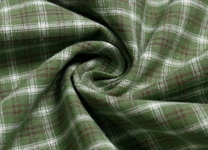 Gros plan détaillé sur la texture du tissu à carreaux verts avec tissage en lin naturel
