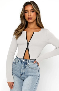 Detail of grey ribbed long sleeve crop top with a double-ended black metal zipper closure
