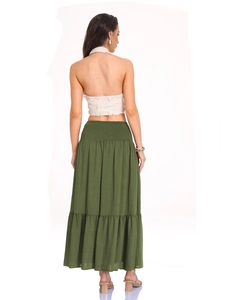 Macro detail of high-waist elastic smocked waistband on a dark green tiered maxi skirt
