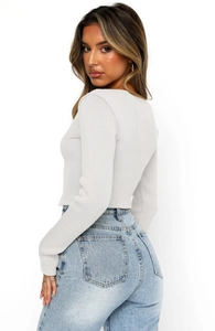 Detail showing the light gray ribbed fabric texture and slim-fit cut of the long sleeve top