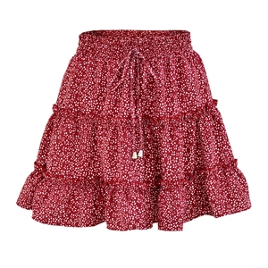 Detail of red floral mini skirt featuring an elastic high waist with decorative drawstring