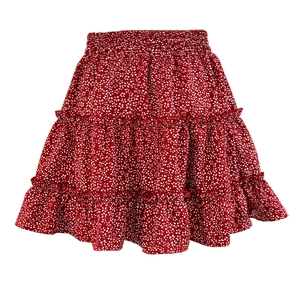 Detailed view of red floral tiered skirt with elastic high waist and ruffle hem design