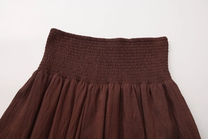 Detail of dark coffee smocked high waist elastic waistband on cotton linen skirt
