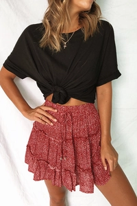 Detail view of the red floral layered mini skirt with ruffles and drawstring accents