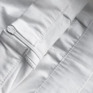 Close-up of white high-waist skirt featuring durable zipper and refined stitching details