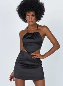 Detail of black satin halter neck crop top and matching mini skirt with silky texture