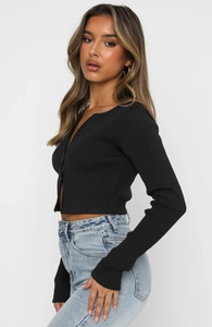 Detail of a slim fit black ribbed knit top with a trendy double zipper closure for women