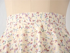 Detail view of floral high-waist chiffon skirt with invisible zipper and yellow pattern