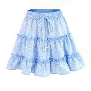 Close-up of light blue floral mini skirt showing layered ruffles and silver drawstring tips