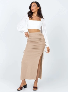 Detail of the side drawstring and high slit on a slim-fit khaki knitted maxi skirt
