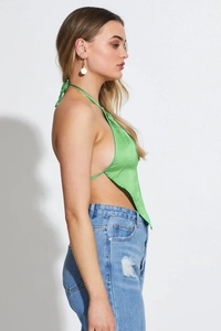 Detail view of a green satin bandana halter top with silky texture and backless design