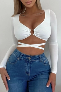 Detail of white long sleeve crop top with metal ring V-neck and crisscross waist ties