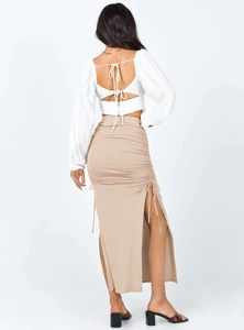 Rear view of slim fit high waist skirt featuring a side slit and elegant lace-up back