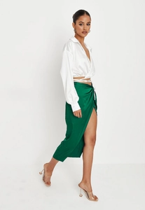 Detailed shot of emerald green satin slit skirt and white tie-front crop top for women