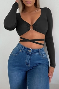 Detail of black long-sleeve crop top with metal ring and criss-cross waist ties