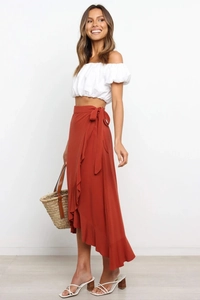 Detail of caramel wrap skirt with asymmetric ruffle hem and tie waist design