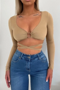 Macro detail of camel crop top featuring metal ring connector and cross-tie waist strings
