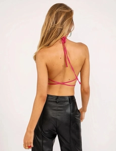 Detailed back view of hot pink halter top with thin criss-cross straps and open back