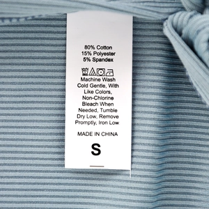 Blue knit midi skirt detail with cotton blend fabric texture and care label info