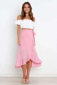 Detail of pink wrap midi skirt with ruffled hem and tie waist on a female model