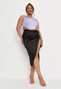 Detailed view of women's purple satin corset top paired with black slit midi skirt