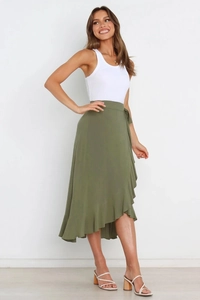 Detail of olive green wrap skirt with ruffled edges and an asymmetrical hemline style