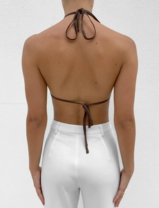 Detail view of deep brown halter top featuring backless tie-up design and bow details