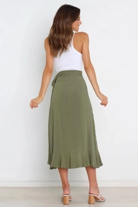Rear view of an olive green wrap skirt with ruffle hem and tie waist on a female model