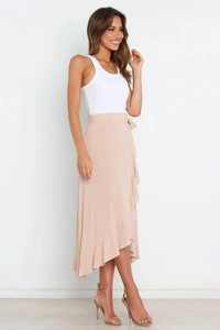 Detail of light apricot wrap midi skirt with ruffle hem and waist tie detail