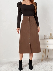 Detail of vintage corduroy A-line skirt with single-breasted buttons and ribbed texture
