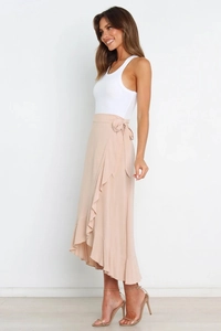 Detail of solid color chiffon wrap midi skirt with ruffle trim and side bow tie closure